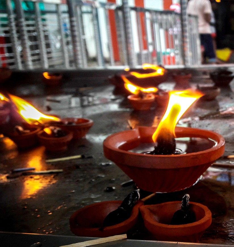 small burning lamp at temple offerings